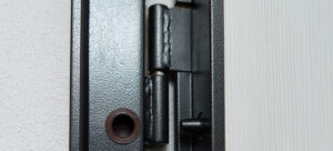 element-de-porte-metallique-moderne-porte-d-acier-robuste-de-pres gros plan sur les gonds de porte métalliques modernes d'acier robuste peints en noir