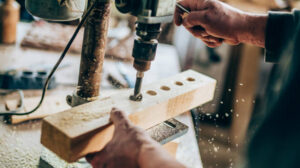perceuse à colonne en cours de perçage du bois