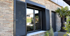 volets coulissants en bois modernes sur la façade de la maison en briques