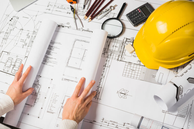 l'architecte ouvre son plan de construction de maison pour le montrer le dessin technique du projet au client